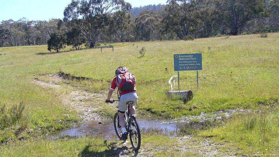 16-Ryan crosses the Vic-NSW border at Cowombat Flat.JPG